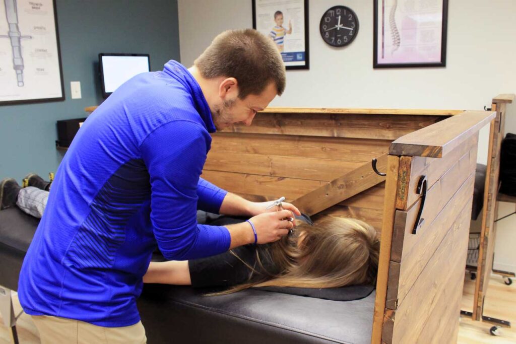 Chiropractor at Advantage Health Center adjusting patient with Torque Release Method