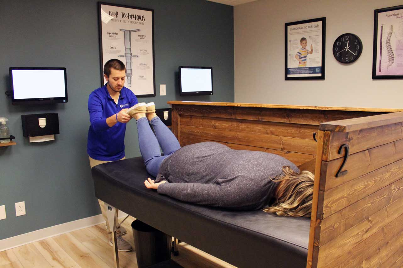 chiropractor showing the patient how the torque release technique works.