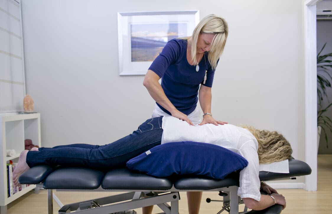 best chiropractor in eau claire adjusting a patients spine.