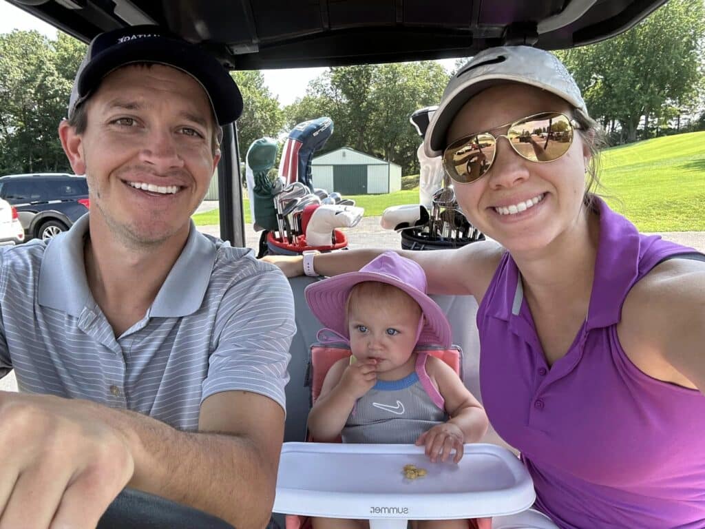 Doctor Zach Bruley with his family on a golf course in Eau Claire.