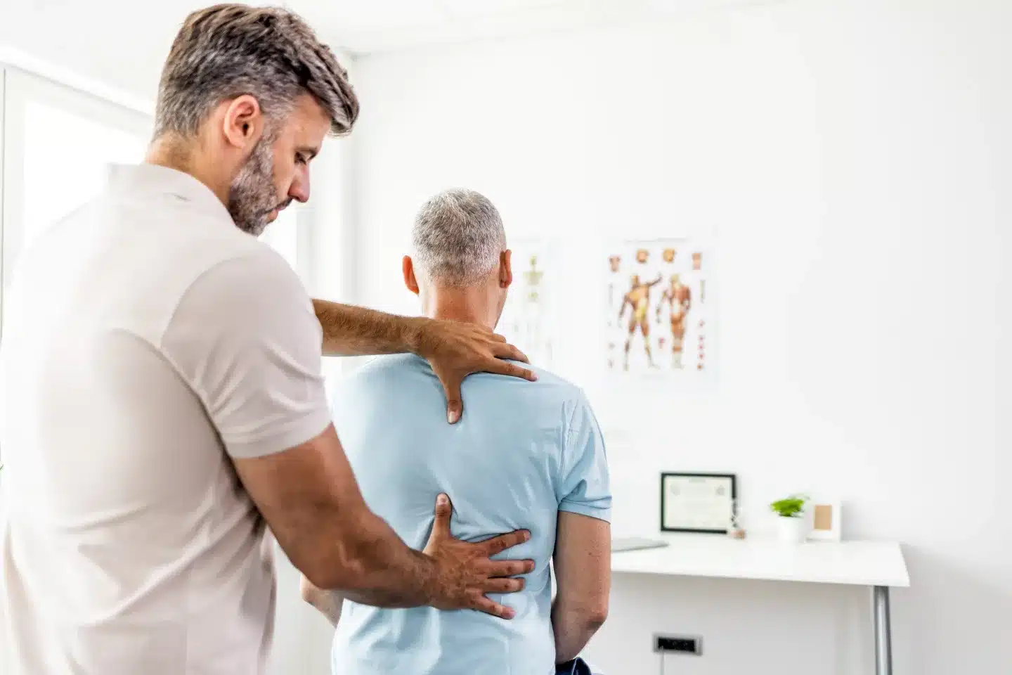 Chiropractor adjusting a patients spine.