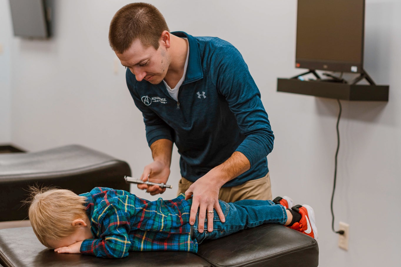 Chiropractor using the Torque Release Technique on a child.